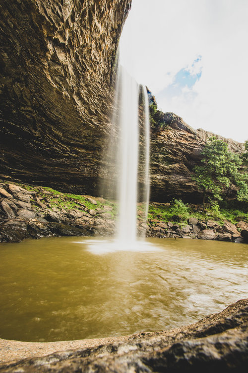 a large waterfall over a body of water